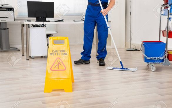 51450258-low-section-of-male-janitor-cleaning-floor-with-mop-in-office